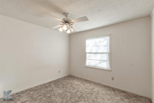 carpeted spare room with ceiling fan, a textured ceiling, and baseboards