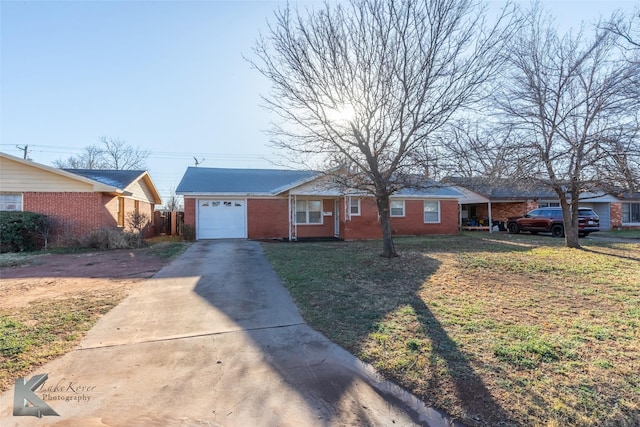 view of front of house featuring an attached garage, driveway, a front lawn, and brick siding