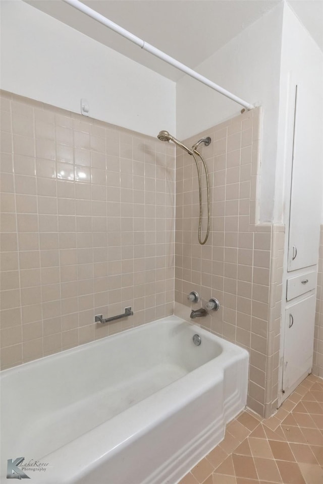 bathroom featuring tile patterned flooring and shower / tub combination