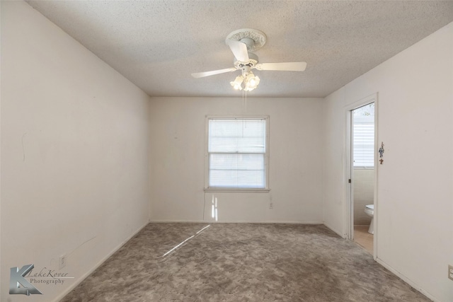 unfurnished room with a textured ceiling, ceiling fan, and carpet