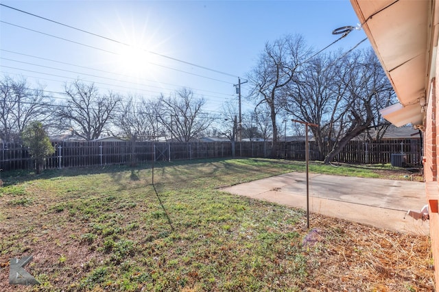 view of yard featuring a fenced backyard, central AC, and a patio