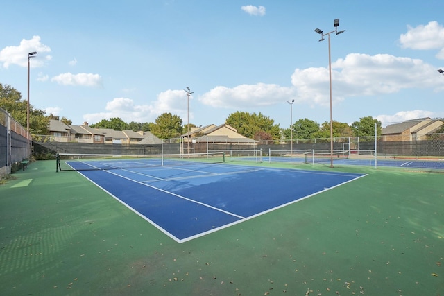 view of sport court featuring fence