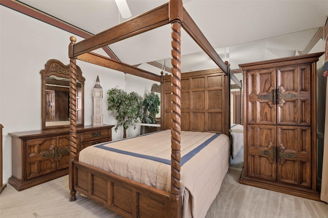 bedroom featuring lofted ceiling with beams and light carpet