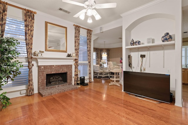 interior space featuring crown molding, wood finished floors, visible vents, and ceiling fan