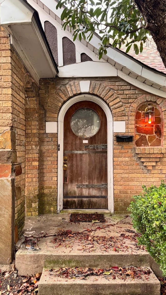 property entrance featuring brick siding