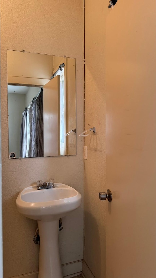 bathroom with a textured wall