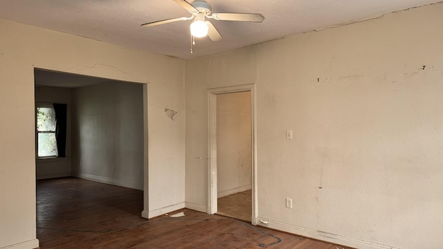 unfurnished room featuring wood finished floors, a ceiling fan, and baseboards