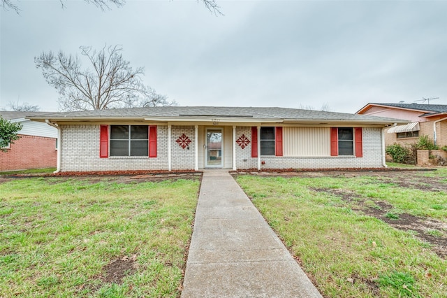 ranch-style home with brick siding and a front yard