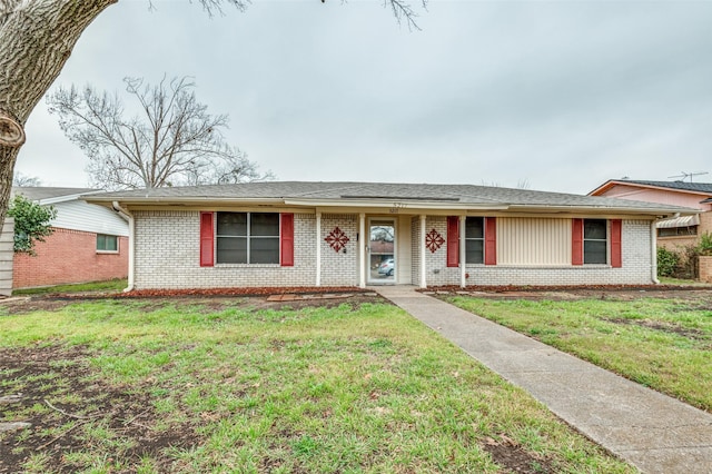 ranch-style home with brick siding and a front yard