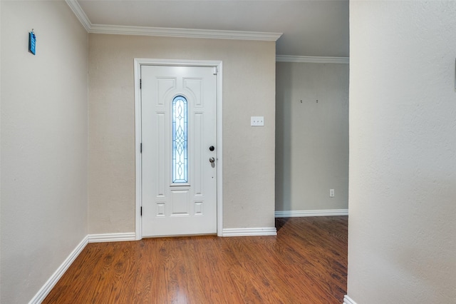 foyer entrance with ornamental molding, wood finished floors, and baseboards