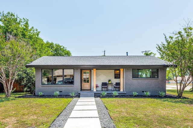 view of front of home with covered porch, brick siding, crawl space, and a front yard