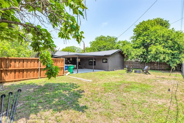 view of yard featuring an outdoor fire pit, a patio area, and a fenced backyard