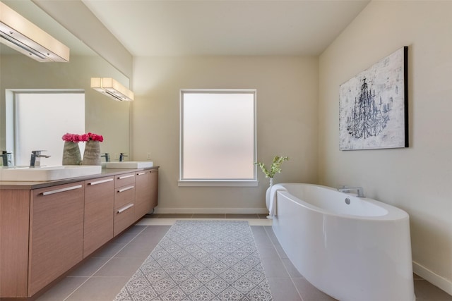 3743 Pistol Creek Dr, Frisco, TX 75034 - bathroom featuring tile patterned floors, double vanity, a soaking tub, a wall mounted AC, and baseboards