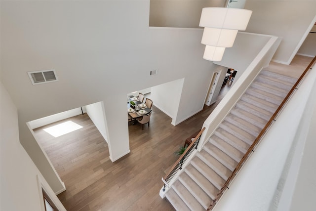 3743 Pistol Creek Dr, Frisco, TX 75034 - staircase featuring a high ceiling, wood finished floors, and baseboards