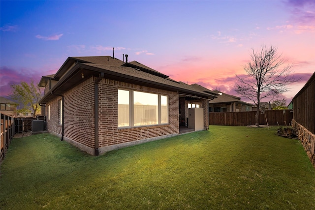 3743 Pistol Creek Dr, Frisco, TX 75034 - property exterior at dusk with brick siding and central AC