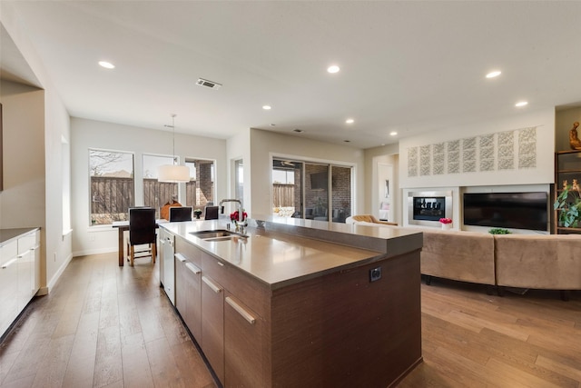 3743 Pistol Creek Dr, Frisco, TX 75034 - kitchen with a sink, modern cabinets, an island with sink, hardwood / wood-style flooring, and recessed lighting