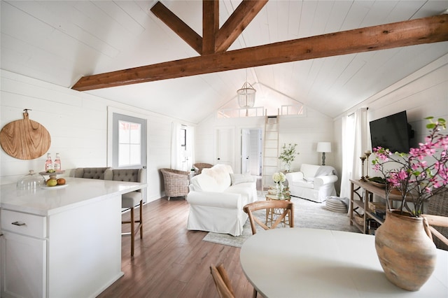 living room with lofted ceiling with beams and wood finished floors