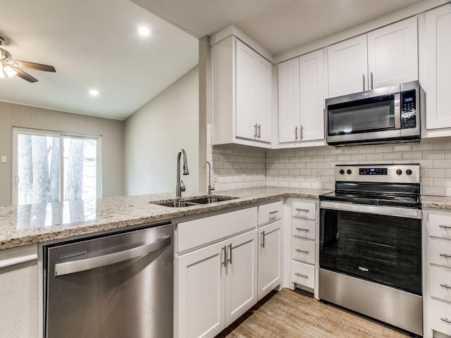 kitchen with white cabinets, stainless steel appliances, and a sink