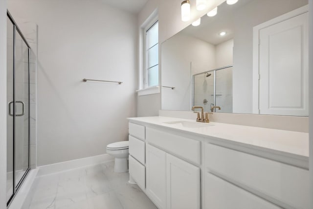 bathroom with toilet, vanity, baseboards, marble finish floor, and a shower stall