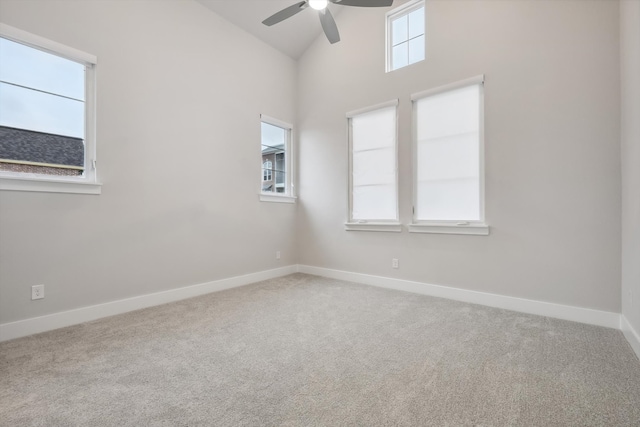 spare room featuring high vaulted ceiling, ceiling fan, baseboards, and carpet flooring