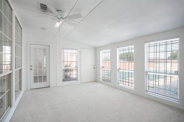 unfurnished sunroom with a healthy amount of sunlight, vaulted ceiling, and a ceiling fan