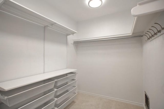 walk in closet featuring carpet floors and visible vents