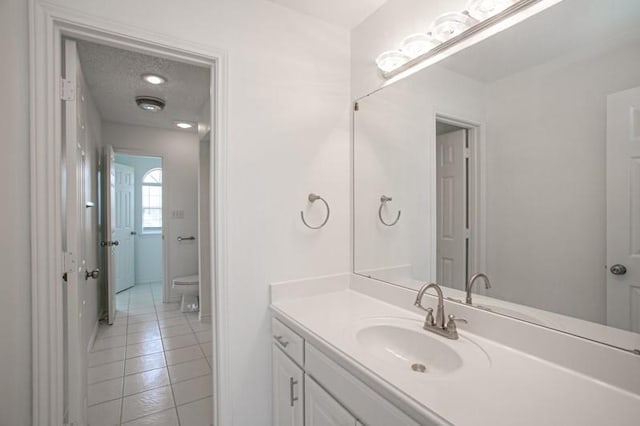 bathroom featuring toilet, vanity, and tile patterned floors