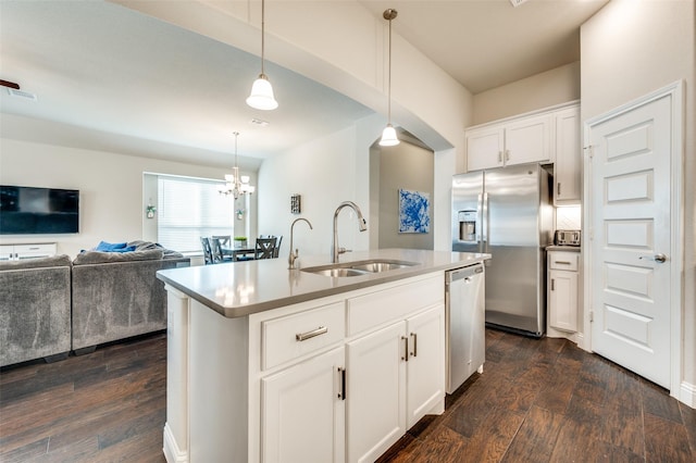 kitchen with visible vents, open floor plan, dark wood-style flooring, stainless steel appliances, and a sink