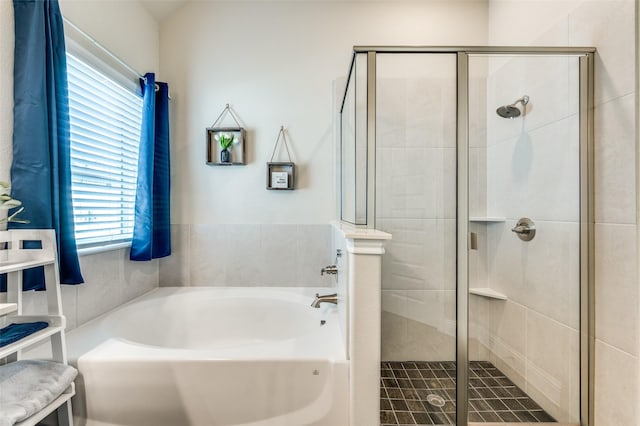 full bathroom with a stall shower and a garden tub