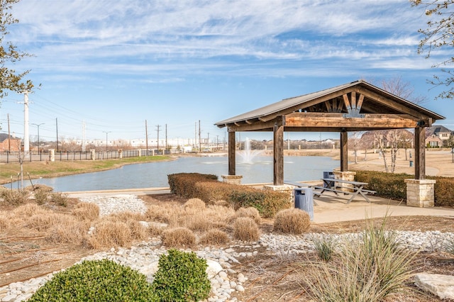 view of property's community with a water view and a gazebo