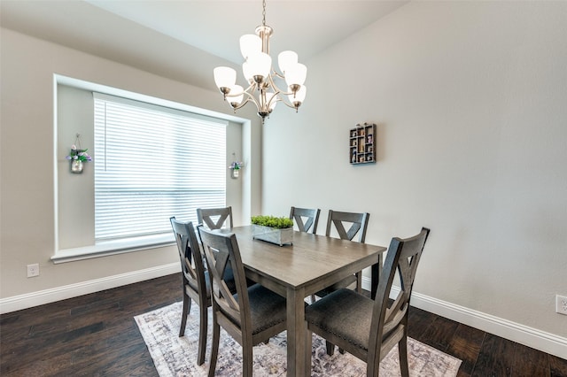 dining area with a chandelier, wood finished floors, and baseboards