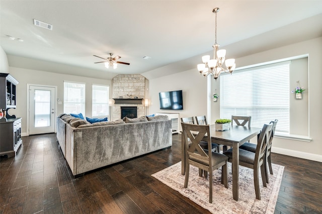 dining room featuring lofted ceiling, dark wood-type flooring, visible vents, and baseboards