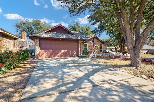 view of front of property featuring a shingled roof, brick siding, driveway, and an attached garage