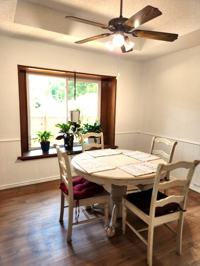 4017 Cherryhill Ct, Arlington, TX 76016 - dining room featuring a wainscoted wall, dark wood-style floors, a ceiling fan, and a textured ceiling