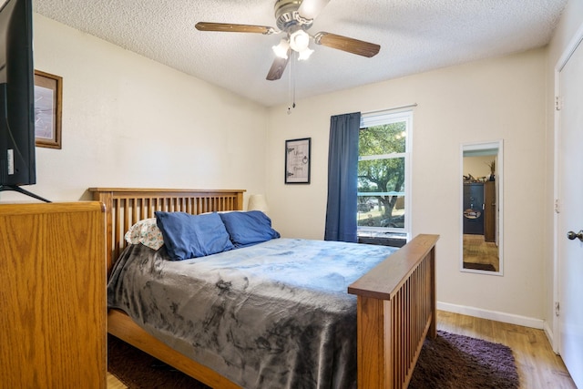 4017 Cherryhill Ct, Arlington, TX 76016 - bedroom featuring wood finished floors, a textured ceiling, baseboards, and a ceiling fan