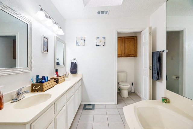 4017 Cherryhill Ct, Arlington, TX 76016 - bathroom featuring tile patterned flooring, toilet, double vanity, a textured ceiling, and baseboards