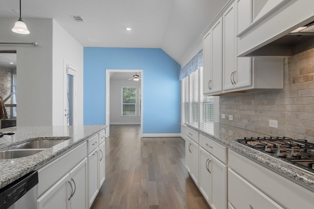 kitchen with stainless steel appliances, tasteful backsplash, custom range hood, visible vents, and a sink