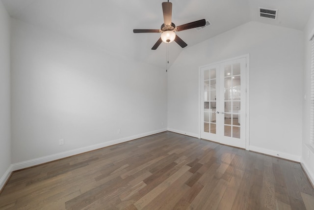 empty room with wood finished floors, visible vents, baseboards, vaulted ceiling, and french doors