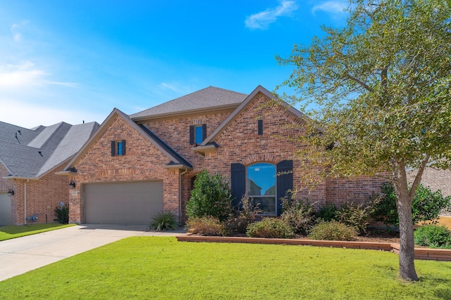 view of front of house with a garage, brick siding, concrete driveway, and a front yard