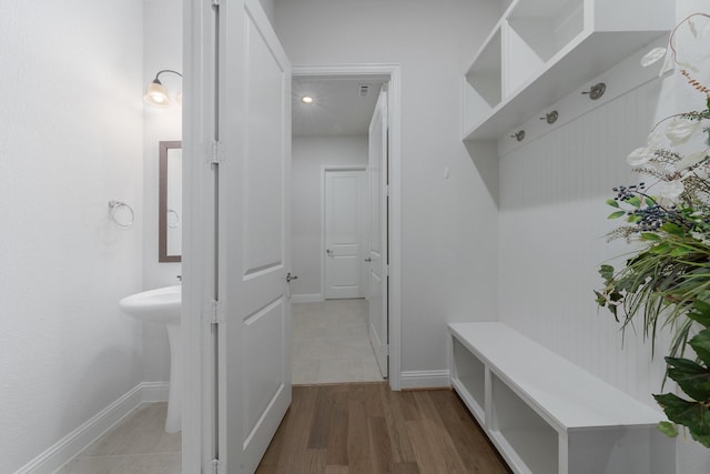 mudroom featuring baseboards and wood finished floors