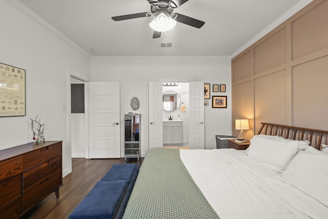 bedroom featuring dark wood finished floors, visible vents, crown molding, and a decorative wall