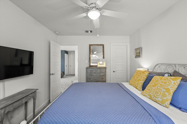 carpeted bedroom with visible vents and ceiling fan