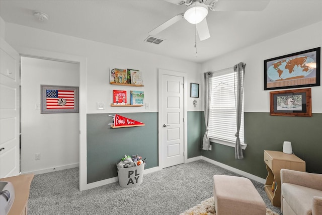 sitting room with a ceiling fan, baseboards, visible vents, and carpet flooring