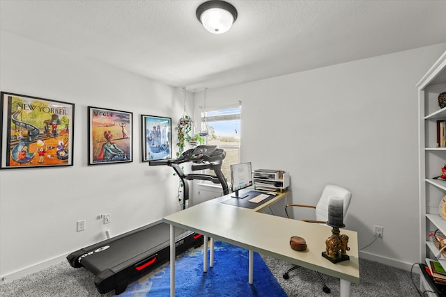 office area featuring carpet floors, baseboards, and a textured ceiling