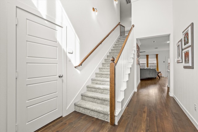 stairway with hardwood / wood-style flooring and baseboards