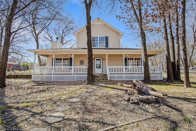 farmhouse-style home with covered porch and a chimney