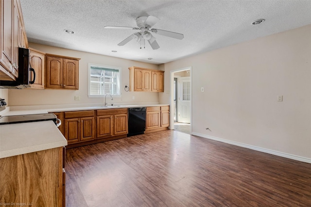 kitchen featuring a sink, a ceiling fan, baseboards, dark wood-style floors, and black appliances