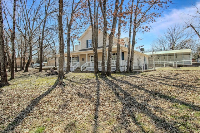 view of front of property featuring a porch and fence