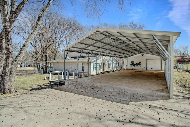 view of parking with a carport and fence