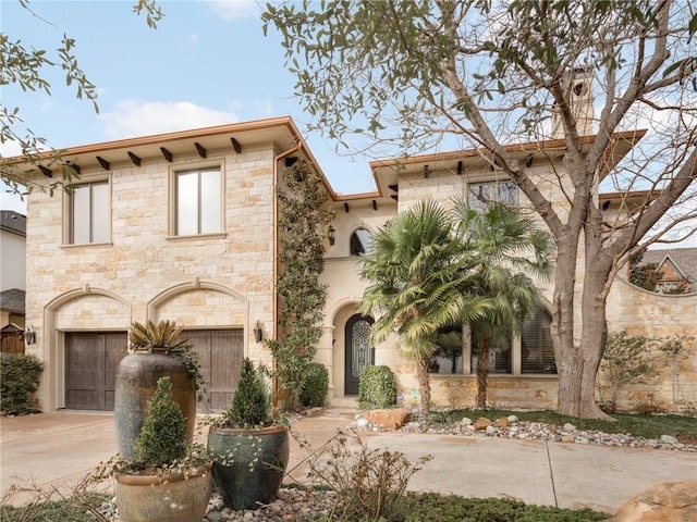 view of front facade featuring concrete driveway and an attached garage